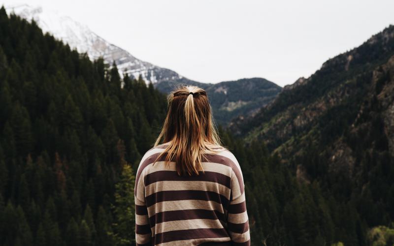 Girl looks out over mountains